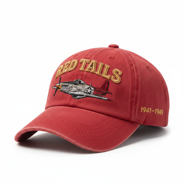Red cap with 'Red Tails' and airplane design on a brown background