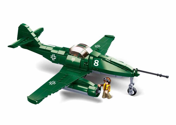 Toy model of a green airplane with a pilot figure on a white background