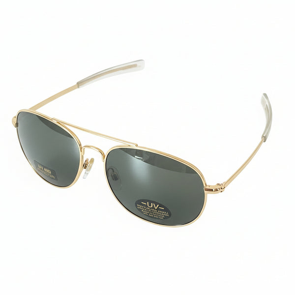 Gold-framed sunglasses on a dark surface