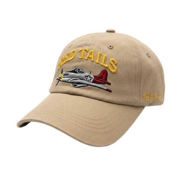 A beige baseball cap with 'RED TAILS' embroidered in yellow on the front.