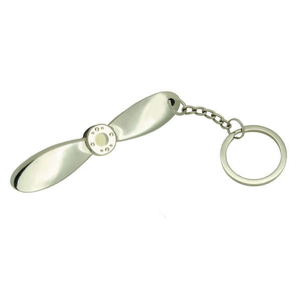 Metallic propeller-shaped keychain on a white background